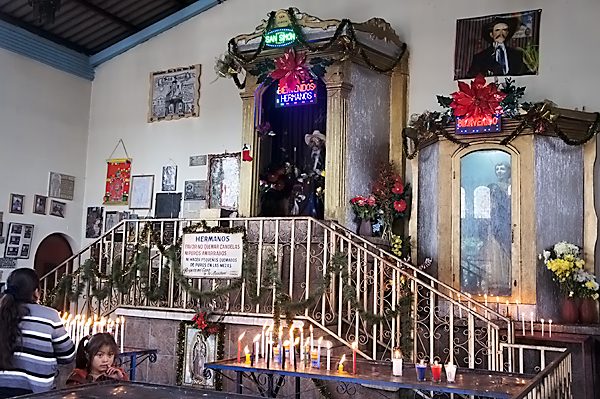 Local woman praying to San Simon