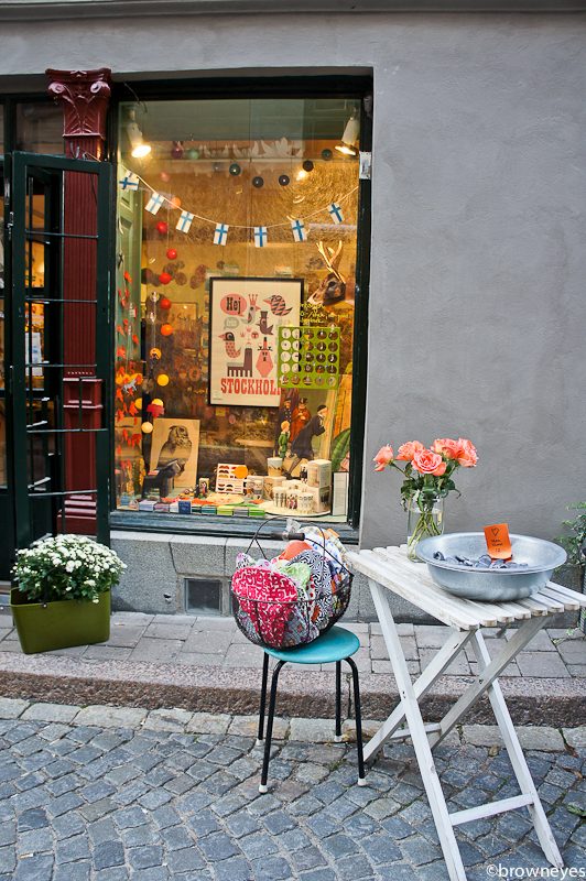 Cute lil' crafts shop with stool and table outside
