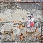 Kids on swing mural right next to the Love Lane signpost.