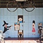 This mural is painted on the door of a shop surrounded by bicycles.